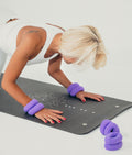 Jolanta with wrist weights on yoga mat